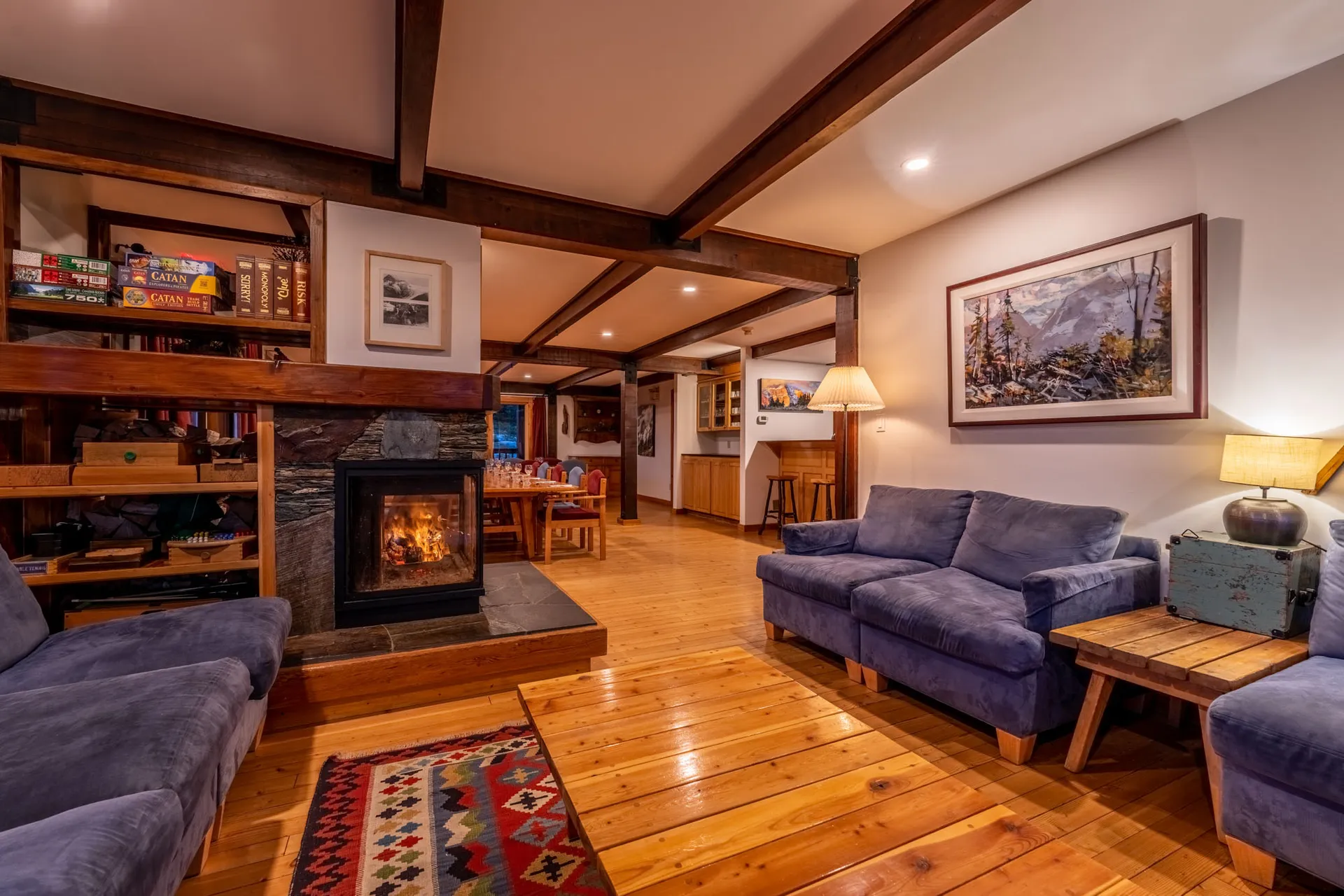 Lodge lounge with a wood fire, sofas, board games and a timber-beamed ceiling